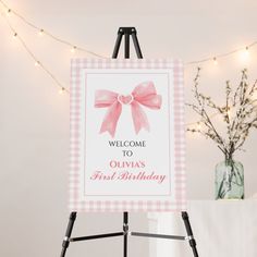 a welcome sign with a pink bow on it