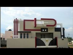 a white and red house with a black gate