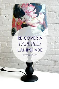 a lamp shade with flowers on it and the words re - cover a tapered lampshade