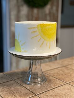 a white and yellow cake sitting on top of a counter