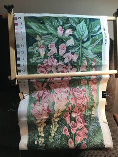 a close up of a piece of cloth with flowers on it and a wooden stick