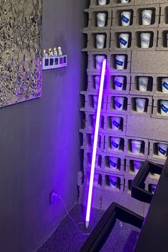 a purple light saber is in the middle of a room with many cups on it