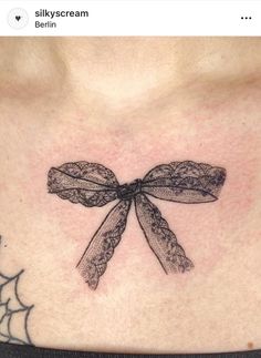 a woman's chest with a dragonfly tattoo on it