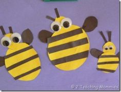 three bees made out of construction paper with googly eyes