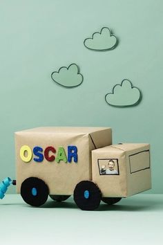 a cardboard box shaped like a truck with the word oscar on it