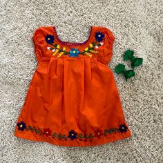 Beautiful Mexican Dress With Bows. Orange Sleeveless Dress For Playtime, Playful Orange Cotton Dress, Cute Orange Cotton Dress, Playful Orange Short Sleeve Dress, Orange Cotton Playtime Dress, Casual Orange Playtime Dress, Casual Orange Dresses For Playtime, Casual Orange Dress For Playtime, Baby Mexican Dress