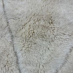 a white sheepskin rug is shown in close up