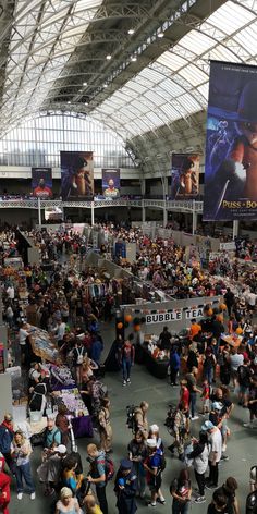 a large crowd of people standing in an airport