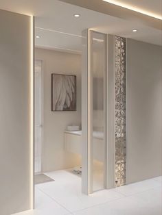 the interior of a modern bathroom with white walls and flooring is lit by recessed lighting