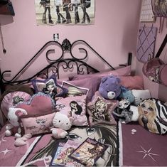 a bed with many stuffed animals on it in a room that has pink walls and black iron bedspread