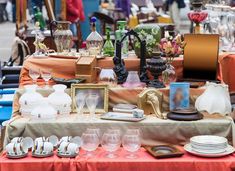 a table topped with lots of dishes and glasses