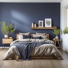 a bedroom with blue walls and wooden floors is pictured in this image, there are plants on the shelf above the bed