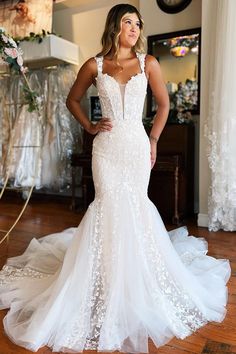 a woman in a wedding dress posing for the camera