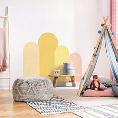 a child's bedroom with a teepee tent and rugs on the floor