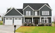 a gray and white house with two garages