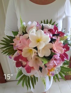 a woman holding a bouquet of pink and white flowers