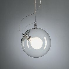 a glass light hanging from a ceiling fixture