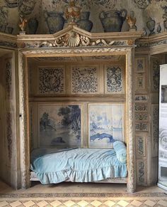 a bed in a room with paintings on the walls