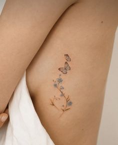 a woman's stomach with butterflies on it