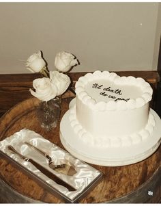 a white cake sitting on top of a wooden table