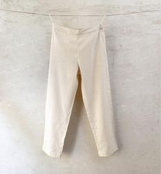 m o d e l  HUMA women's pull-on pants in handwoven handspun organic cotton. light, comfortable and versatile  - elastic at back of waist  - side pockets  f a b r i c doubled karunganni cotton: handspun and handwoven indigenous Indian organic cotton  c o l o u r - natural white (kora) s i z e s length all sizes 37,5'' which can be extended 2'' through letting down the hem XXS waist    26'' hip       44'' XS waist    28'' hip       46'' S waist    30'' hip        48'' M waist    32'' hip        50 Loosely Fitted Cotton Capris, Non-stretch Cotton Cargo Pants, Cotton Straight Capris For Workwear, Cotton Capris For Workwear In Straight Style, Cream Cropped Leg Cotton Pants, Cream Relaxed Fit Cropped Bottoms, Relaxed Fit Cream Cropped Leg Pants, Cream Relaxed Fit Cropped Pants, Cotton Cropped Leg Capris