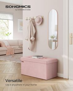 a pink bench sitting in front of a mirror next to a white couch and door