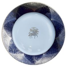 a blue and white plate with an image of a horse on the front, sitting in a bowl