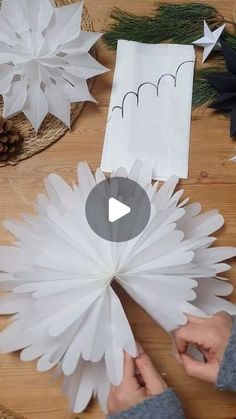 someone is making paper snowflakes on the table