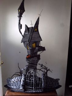 a halloween scene with a creepy house and spooky trees on the top of it