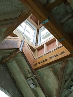 the inside of an unfinished building with a skylight in the center and windows above it