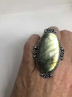 Huge blue green Labradorite rainbow moonstone Lovely vintage silver setting is low content silver Size 7.5 Can be re sized for you for $10-$20 jeweler's fee About an inch long Ring is long covers from knuckle to knuckle. All rings are shipped free in the US in a nice gift box. Check out our over a THOUSAND great reviews Engraving is $4 per letter and is not always perfect depending on the piece. It can take a few days if the jeweler is busy. This is payable to Paypal Judithsltd@gmail.com Vintage Large Moonstone Ring In Sterling Silver, Antique Silver Moonstone Ring, Vintage Silver Moonstone Ring With Large Stone, Silver Moonstone Ring With Large Stone For Healing, Bohemian Oval Labradorite Jewelry, Handmade Antique Oval Moonstone Ring, Antique Oval Moonstone Ring Handmade, Vintage Oval Labradorite Jewelry, Oval Silver Labradorite Gemstones