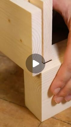 a person is working on a piece of wood with one hand and the other hand