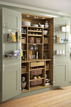 an open cabinet in a kitchen with lots of cupboard space