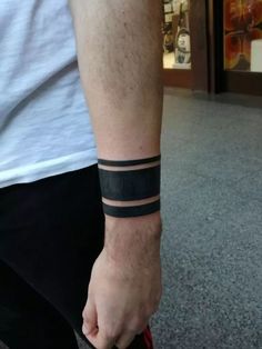 a man with a wrist band on his arm