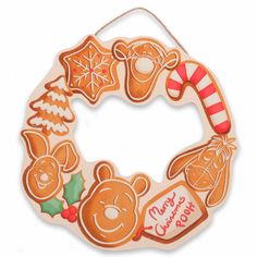 an ornament shaped like a christmas wreath with gingerbreads, cookies and candy