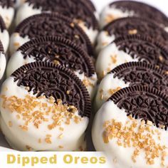 oreo cookies with white frosting and sprinkles are arranged on a plate