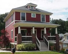 a red two story house with white trim