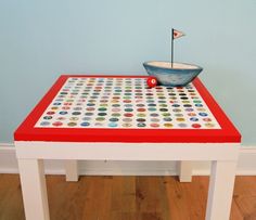 a red table with a bowl on it and a flag sticking out of the top