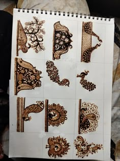 an open notebook with various designs on it