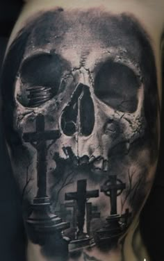 a man with a skull and cross tattoo on his back, in black and white