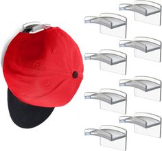 a red hat is hanging on the side of a wall with six clear shelves in front of it