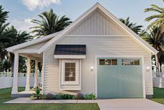 a small white house with palm trees in the back ground and a blue garage door