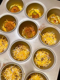 twelve cups filled with different types of food in them on a tray, ready to be cooked