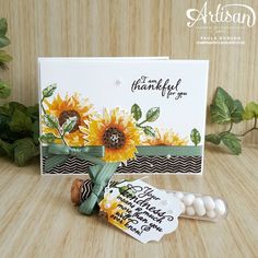 a card with sunflowers on it next to some candy