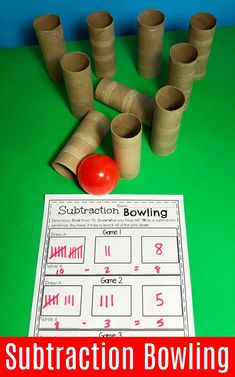 the subtraction bowling game is ready to be played on the table with paper rolls