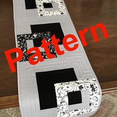 a quilted table runner with the letters d and f on it's sides