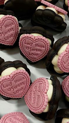 some heart shaped cookies are sitting on a table with chocolates in the shape of hearts