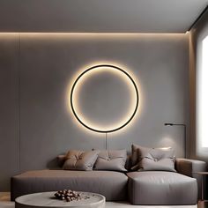 a living room filled with furniture and a circular light fixture above the couch in front of it