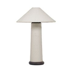 a white lamp sitting on top of a table