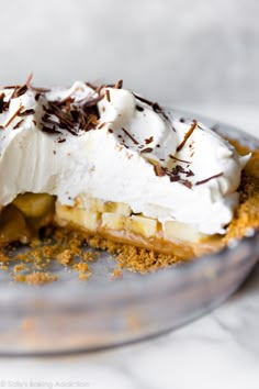 a banana split pie with whipped cream and chocolate shavings on top, ready to be eaten